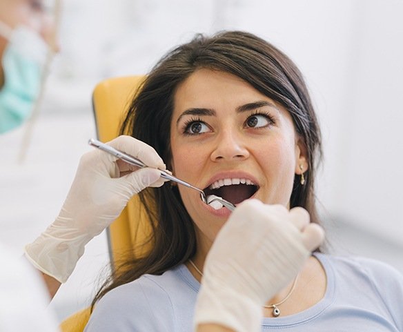Woman having a tooth extracted