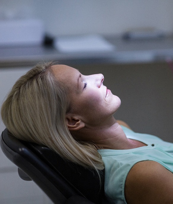 Woman relaxed in dental chair after nitrous oxide sedation in Lincoln, NE