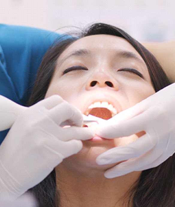 Female patient and dentist performing root canal therapy in Lincoln, NE