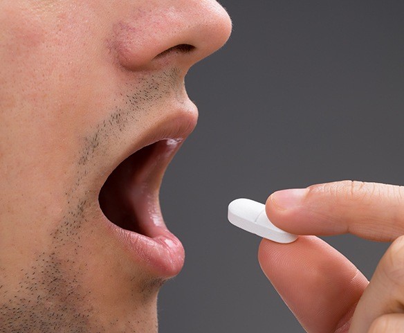 Patient taking oral conscious sedation pill