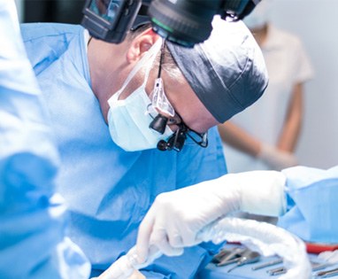 Periodontist performing surgery to place dental implants in Lincoln, NE