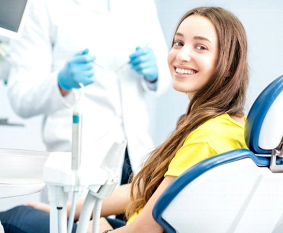 Woman smiling during visit with periodontist in Lincoln