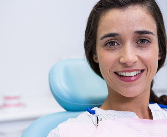 Woman smiling after getting dental implants in Lincoln, NE