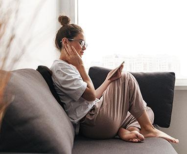 Woman resting at home after getting dental implants in Lincoln, NE