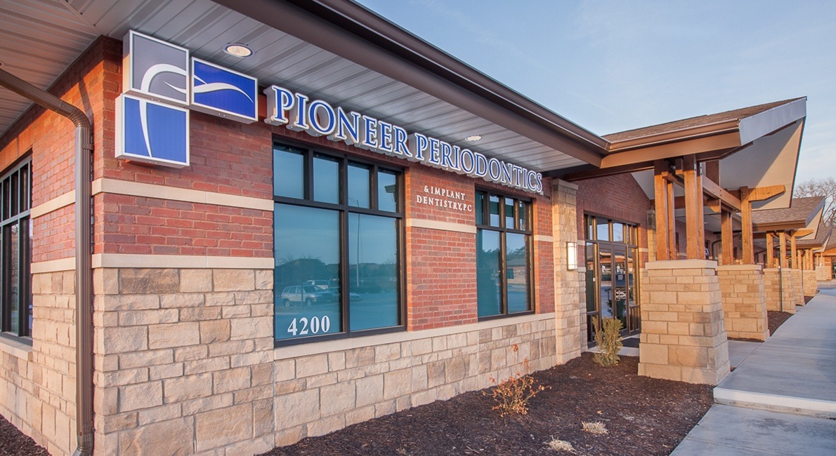 Pioneer Periodontics and Implant Dentistry sign on office wall