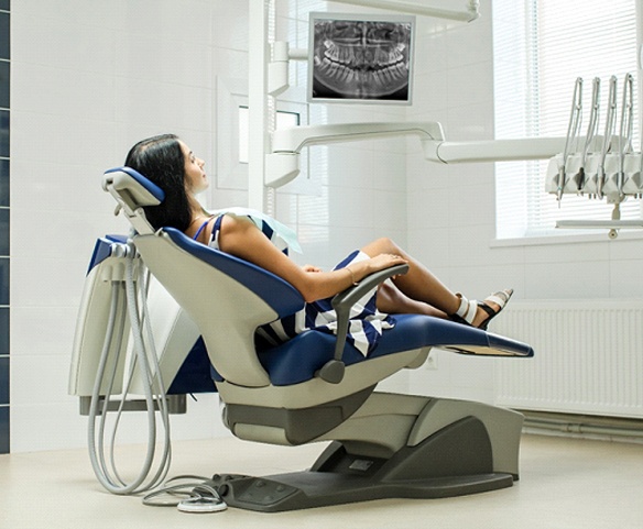 Relaxed female patient, reclining in dental chair before treatment