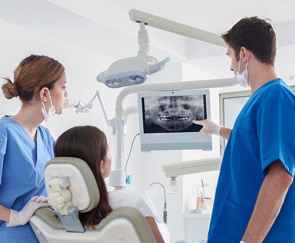 Periodontist and patient looking at digital X-Rays