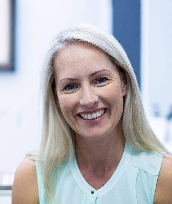 Female patient smiling after full mouth reconstruction in Lincoln, NE