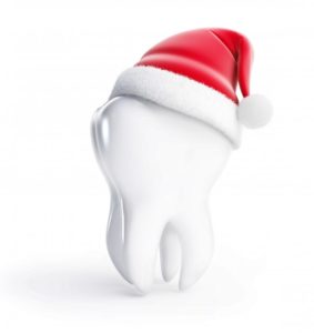 tooth with Santa hat for maximizing dental insurance benefits this holiday
