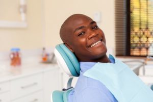 Man smiling after getting implant dentures in Lincoln 