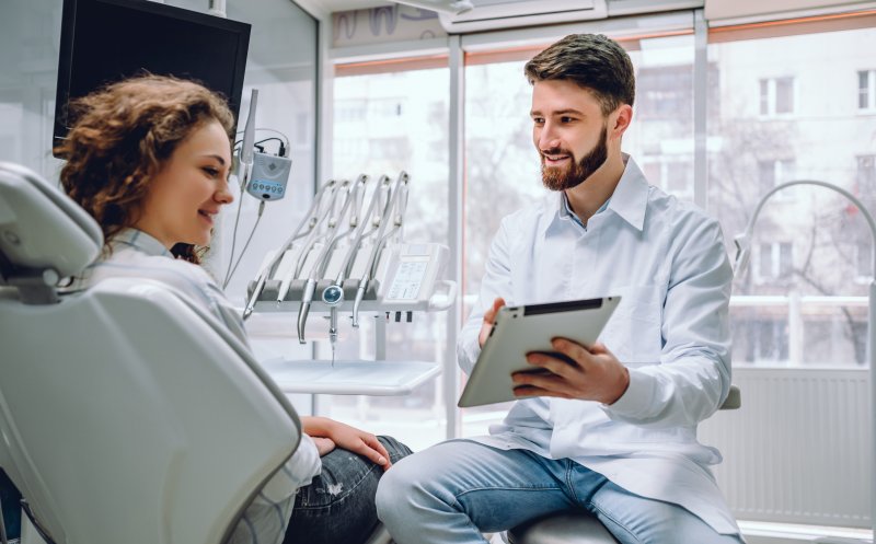 A patient visiting with her dentist to fix her smile